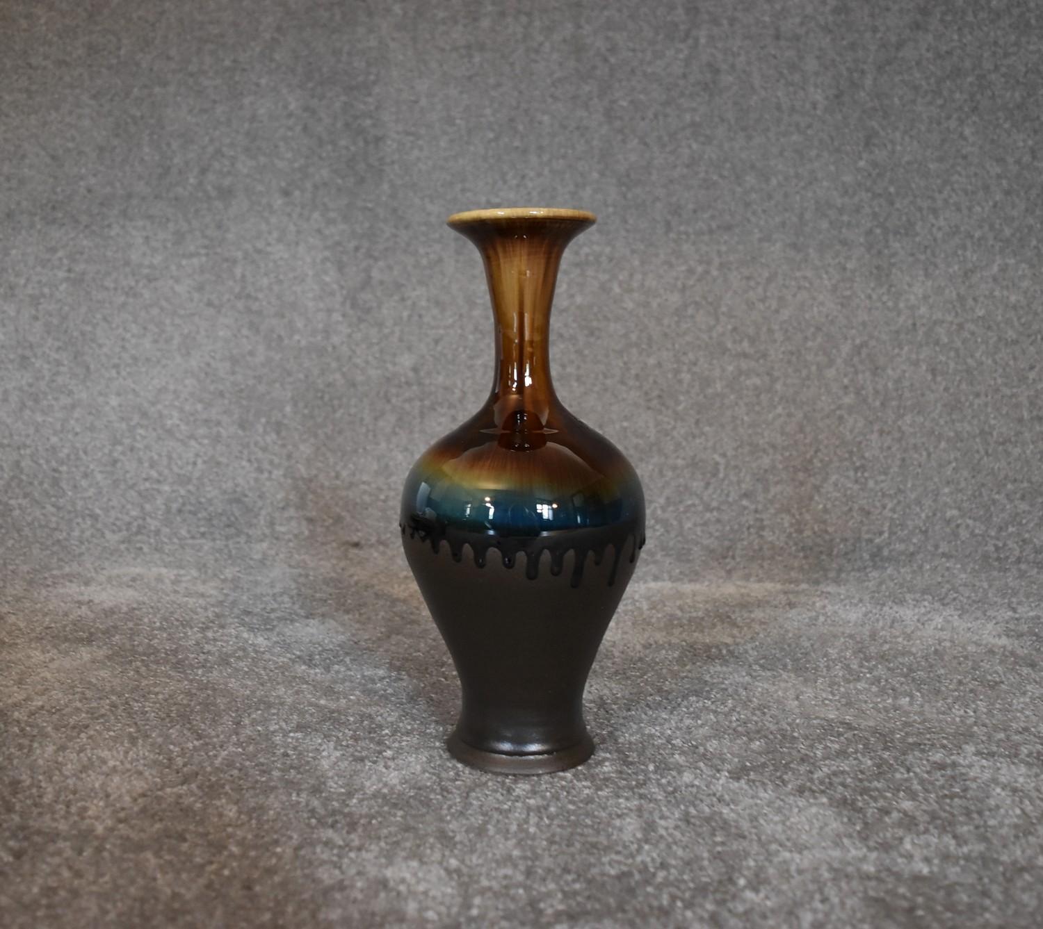 A tall Persian drip glazed vase. H.30cm