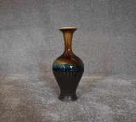 A tall Persian drip glazed vase. H.30cm