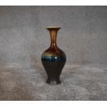 A tall Persian drip glazed vase. H.30cm
