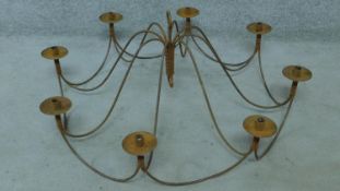 A wrought metal eight branch ceiling candle chandelier. H.44 W.102cm