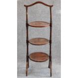 An Edwardian mahogany and inlaid three tier cakestand. H.90cm