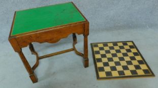 A mid 20th century oak Jacobean style baize lined games table together with an inlaid chess board.