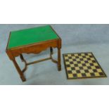 A mid 20th century oak Jacobean style baize lined games table together with an inlaid chess board.