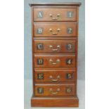 A tall mahogany filing chest with inset tooled leather top and lettered and numbered drawers on