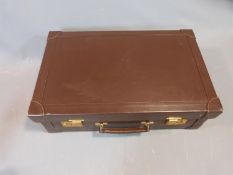 A Mappin & Webb brown leather travelling case, pale suede interior, brass clip locks, Mappin &