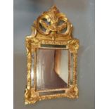 An antique Florentine gesso and carved giltwood wall mirror with original plates. H72.5