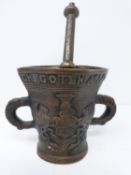 An antique bronze pestel and mortar, with inscription in Dutch and armorial crest. Height 23cm.