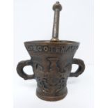 An antique bronze pestel and mortar, with inscription in Dutch and armorial crest. Height 23cm.