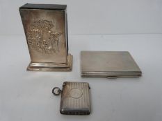 A silver match holder, cigarette case and vesta case. Match box holder with repousse work