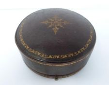 An antique round travel clock in leather gilded case by Edwards & Sons of Glasgow, 161 Regent