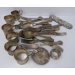 A collection of silver plated cutlery, cup covers and other items.