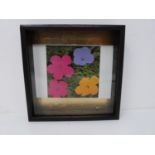A framed Andy Warhol lithograph of flowers. In box frame on gold leaf panel. Stamped with Andy