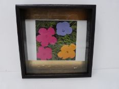 A framed Andy Warhol lithograph of flowers. In box frame on gold leaf panel. Stamped with Andy