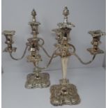 A pair of silver plated candelabra. Repoussé work, elegant swirled design, flame removable finial