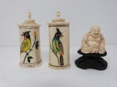 Two bone scent bottles with painted birds and a carved ivory buddah on carved hardwood stand.