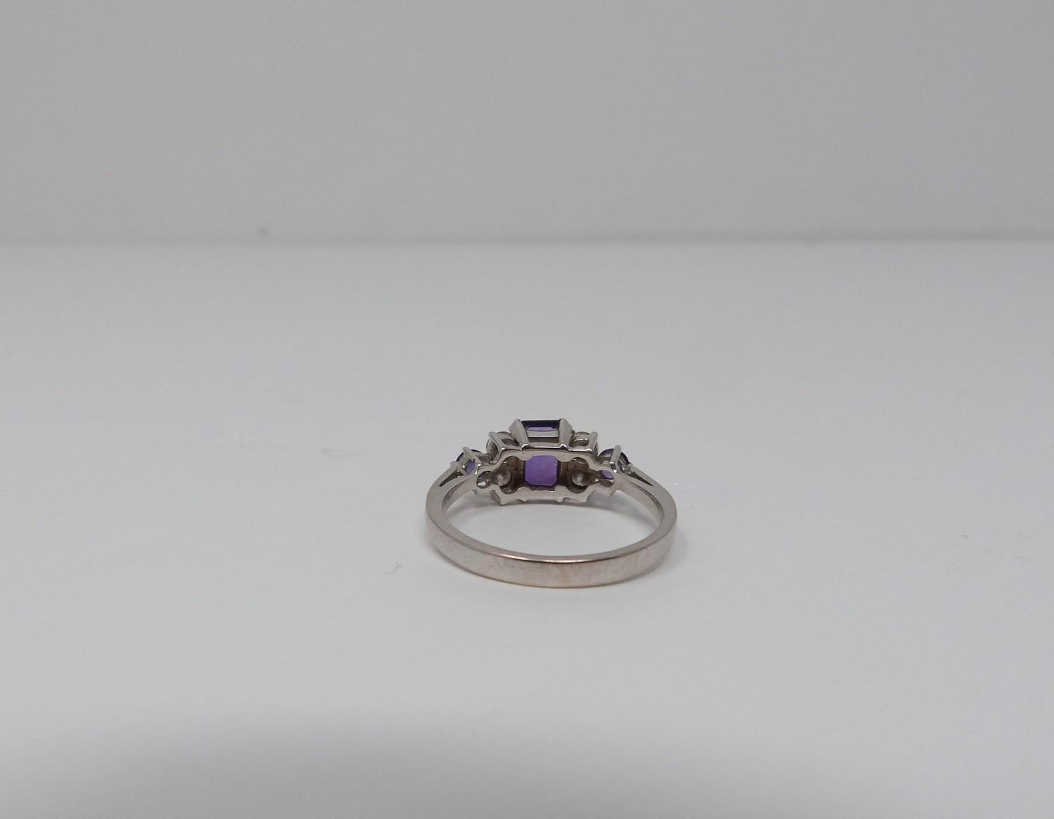 An Amethyst and diamond 18ct white gold ring, set to centre with a emerald cut amethyst in a four - Image 5 of 8