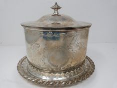 An engraved silver plated biscuit barrel on pierced stand, engraved with ribbon and stylized foliate