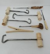 A collection of boot pulls and a glove stretcher, some with bone handles, one with deer antler