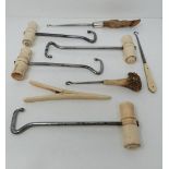 A collection of boot pulls and a glove stretcher, some with bone handles, one with deer antler