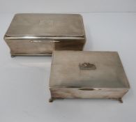 A pair of wooden lined silver cigarette boxes, the larger one with engine turned decoration and