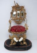 Globe de Mariee on a wooden stand, with red velvet cushion and gilded repousse work depicting birds,