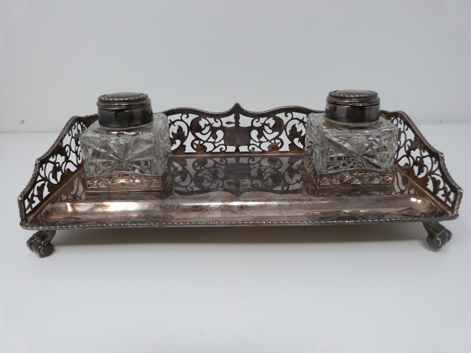 A silver and glass piercework desk inkwell, two bottles with silver tops and rope edging. Ink