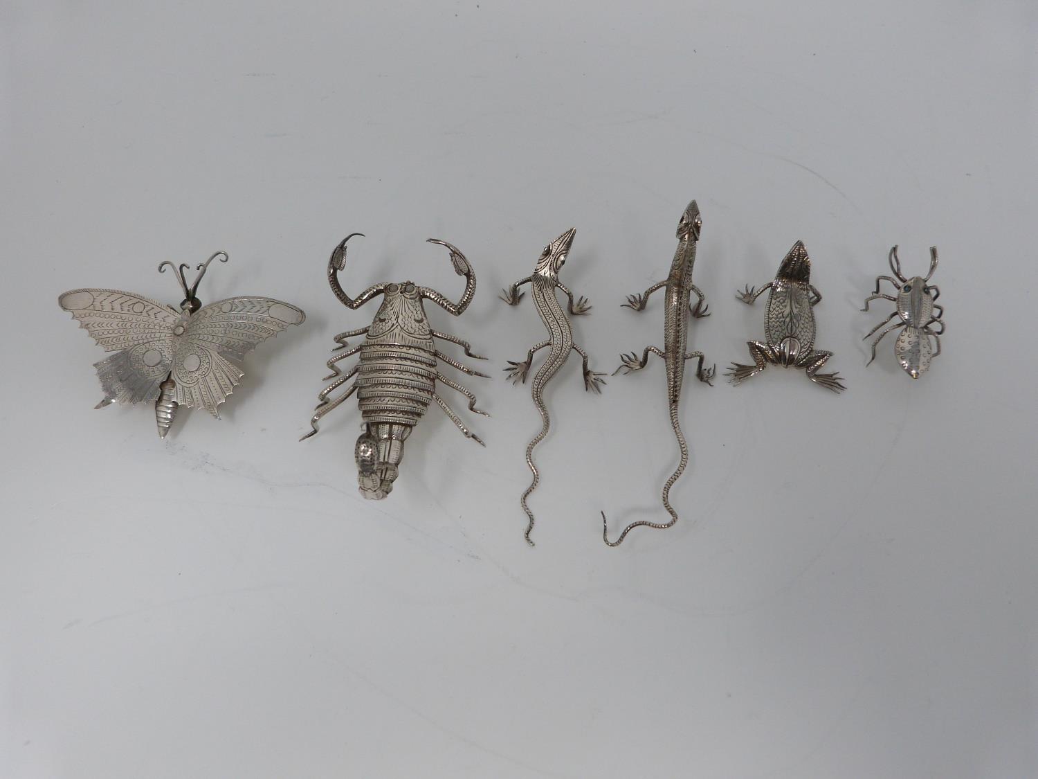 A collection of six Indian white metal animals, including a scorpion, butterfly, lizard, iguana, ant