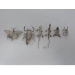A collection of six Indian white metal animals, including a scorpion, butterfly, lizard, iguana, ant