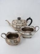 A three piece matching silver tea set, hallmarked: HEBFEB for Barker Brothers (Herbert Edward Barker