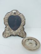 A silver heart photo frame and dish, photo frame with repousse silver design with cherubs and