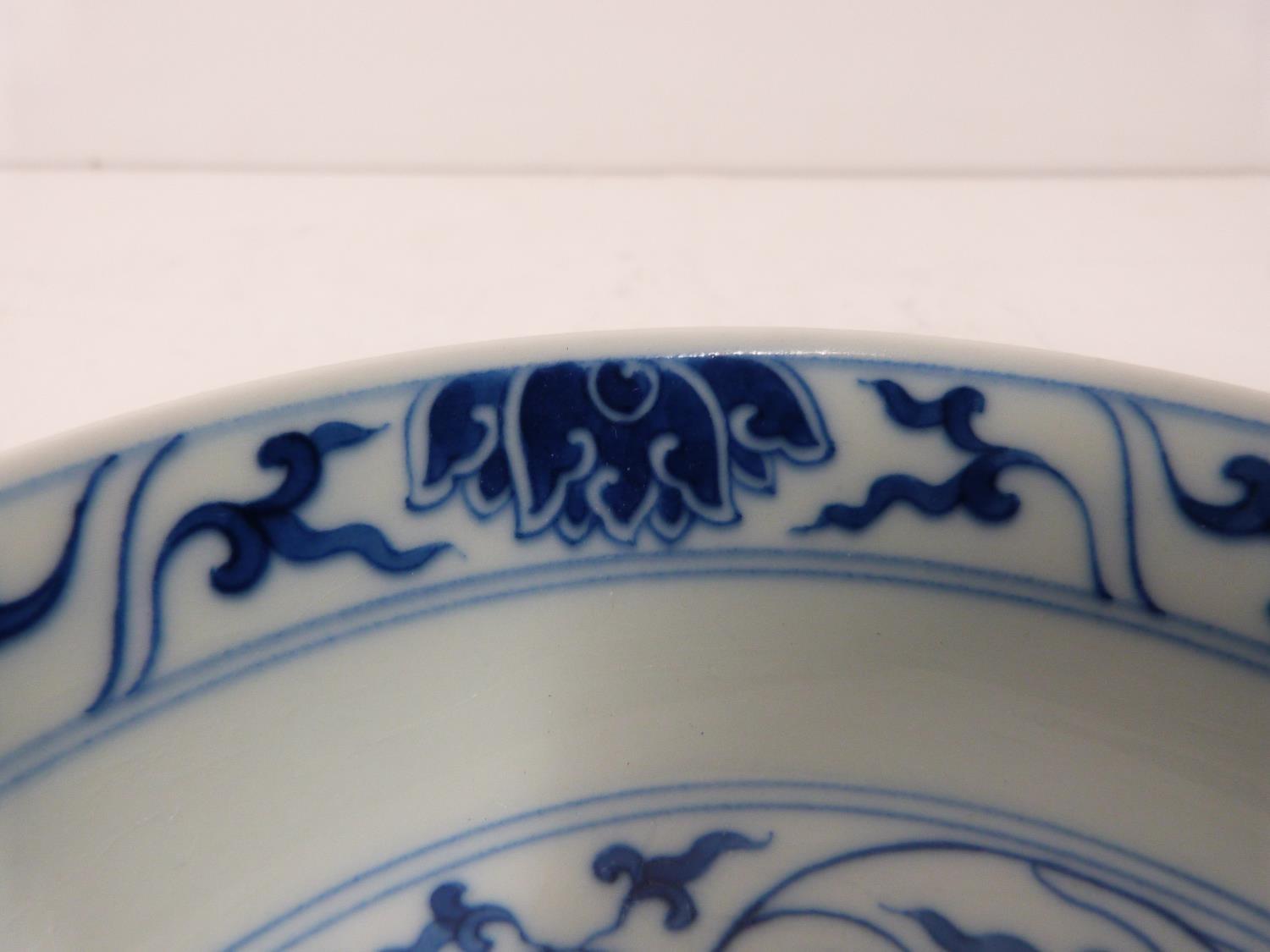 A Chinese blue and white porcelain saucer dish with foliate scroll and floral decoration, six- - Image 6 of 6