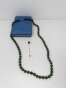 A nephrite necklace with a 10 carat gold clasp. Comprises of 72 round polished nephrite beads, all