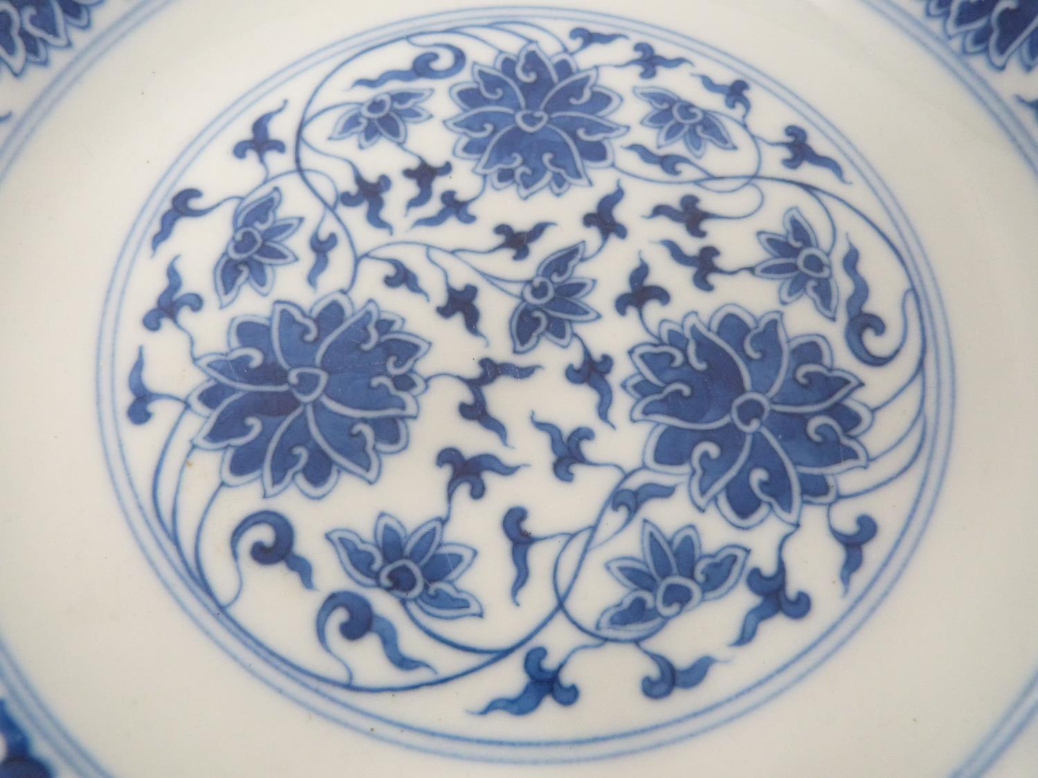 A Chinese blue and white porcelain saucer dish with foliate scroll and floral decoration, six- - Image 2 of 6