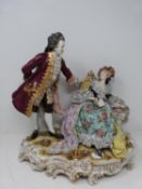 A German porcelain Volkstedt scene, with a gentleman and lady sitting on s scrolling gilded base.
