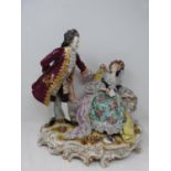 A German porcelain Volkstedt scene, with a gentleman and lady sitting on s scrolling gilded base.