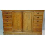 A Regency mahogany press cupboard with fitted central panel doors enclosing linen slides, flanked by