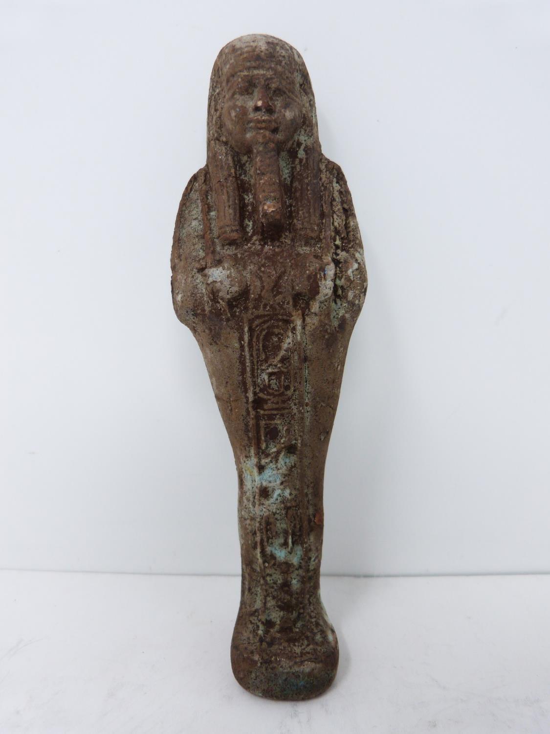 An antique replica of an Egyptian Shabti, pale blue glaze and hieroglyphs to front. Height 4.5cm.