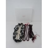 A three strand gemstone necklace and four strands of almandine garnet beads. The three strand