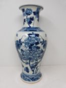 A Kangxi style blue and white baluster dragon vase with floral motifs. Four character mark to