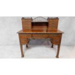 A Georgian mahogany pedestal desk in the Chinese Chippendale style fitted arrangement of drawers and