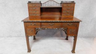 A Georgian mahogany pedestal desk in the Chinese Chippendale style fitted arrangement of drawers and