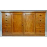 A mid 19th century mahogany press cupboard fitted central section with panel doors enclosing linen