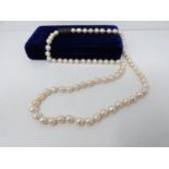 A vintage baroque cultured pearl necklace with an abstract white metal non opening clasp with brooch