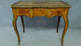 A 19th century burr walnut and kingwood crossbanded writing table with ormolu mounts and allover