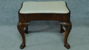 A mid Georgian mahogany footstool raised on cabriole legs with lions paw feet and shell carving. H.