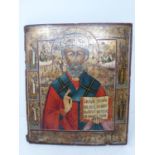 A 18th century hand painted Russian icon, painted on wood with engraved cyrillic script to the back.