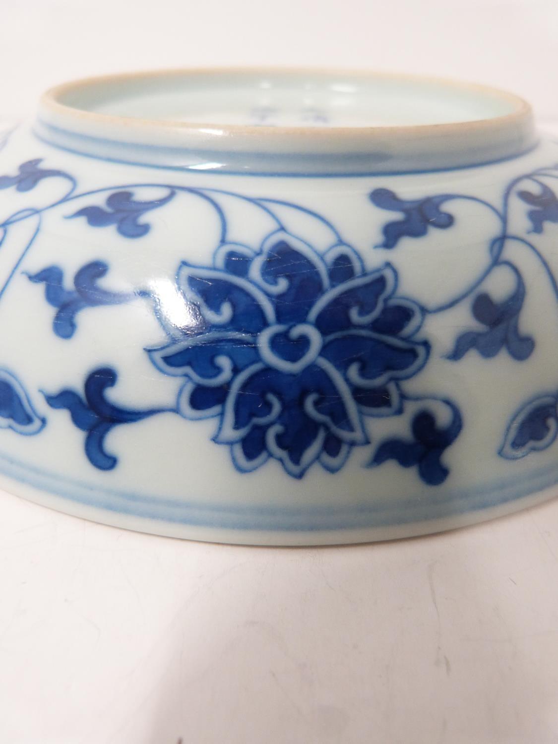 A Chinese blue and white porcelain saucer dish with foliate scroll and floral decoration, six- - Image 5 of 6