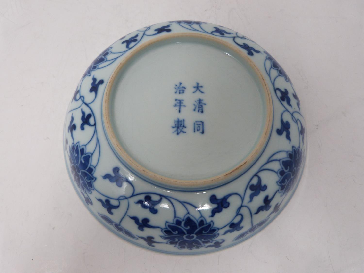 A Chinese blue and white porcelain saucer dish with foliate scroll and floral decoration, six- - Image 3 of 6