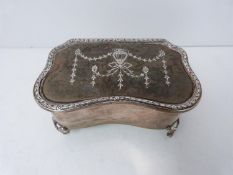 An Edwardian silver and tortoise shell pique work tricket box. Velvet interior. Bow form feet.