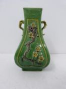 A Kangxi style green-glazed square-section vase with relief prunus decoration. Height 13.7cm.